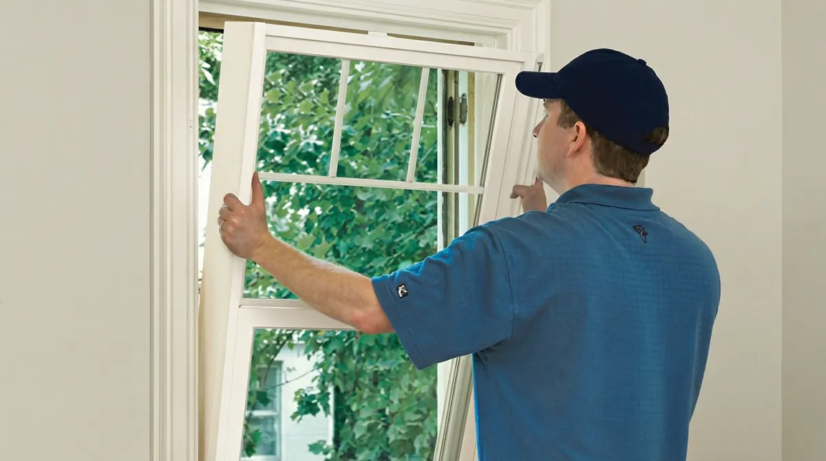 Professional contractors performing a residential window insulation and replacement service in Manchester, NH